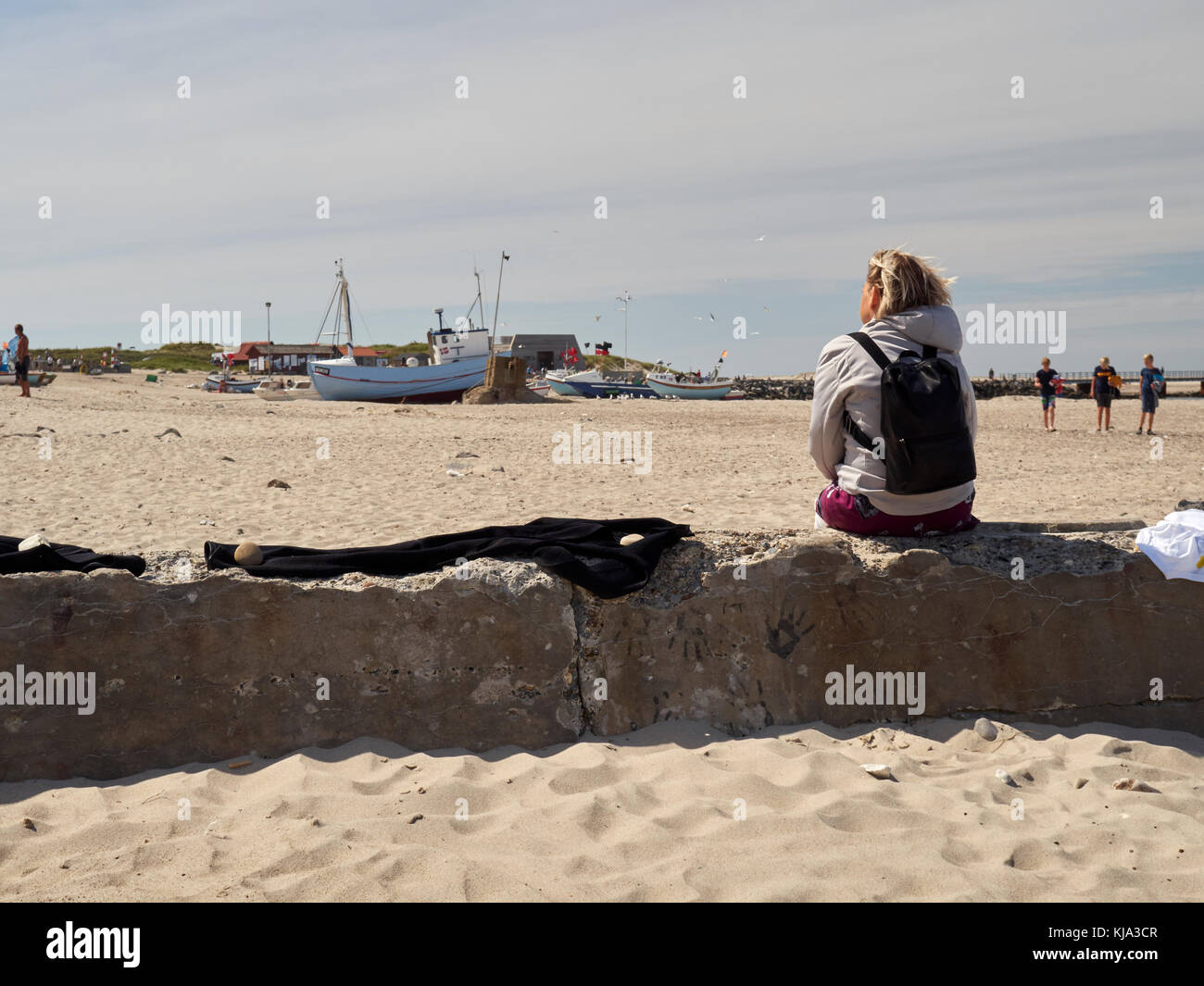 Woman enjoying the sun, Nr. Vorupør, Denmark Stock Photo