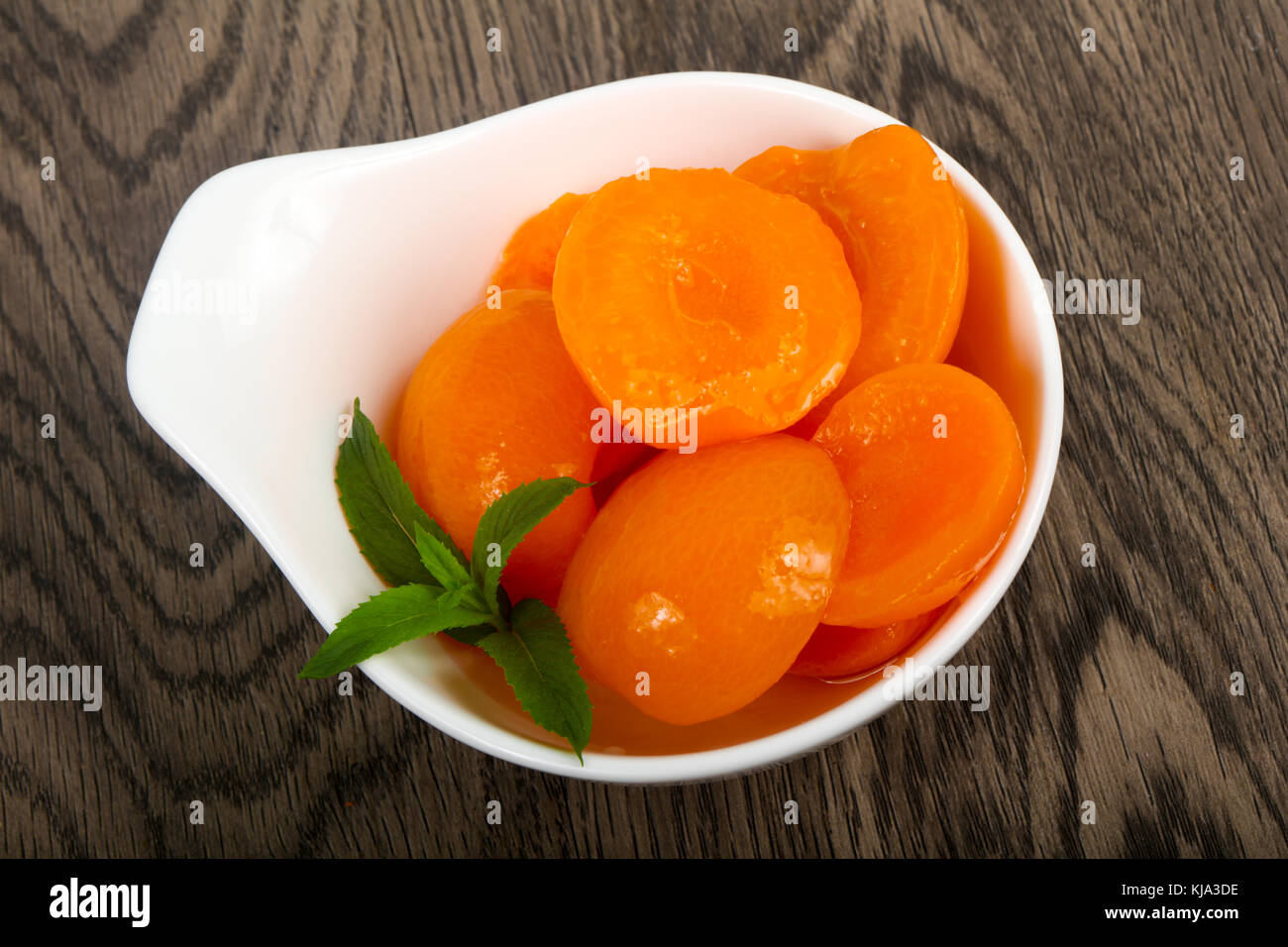 Canned apricots with mint leaves Stock Photo Alamy