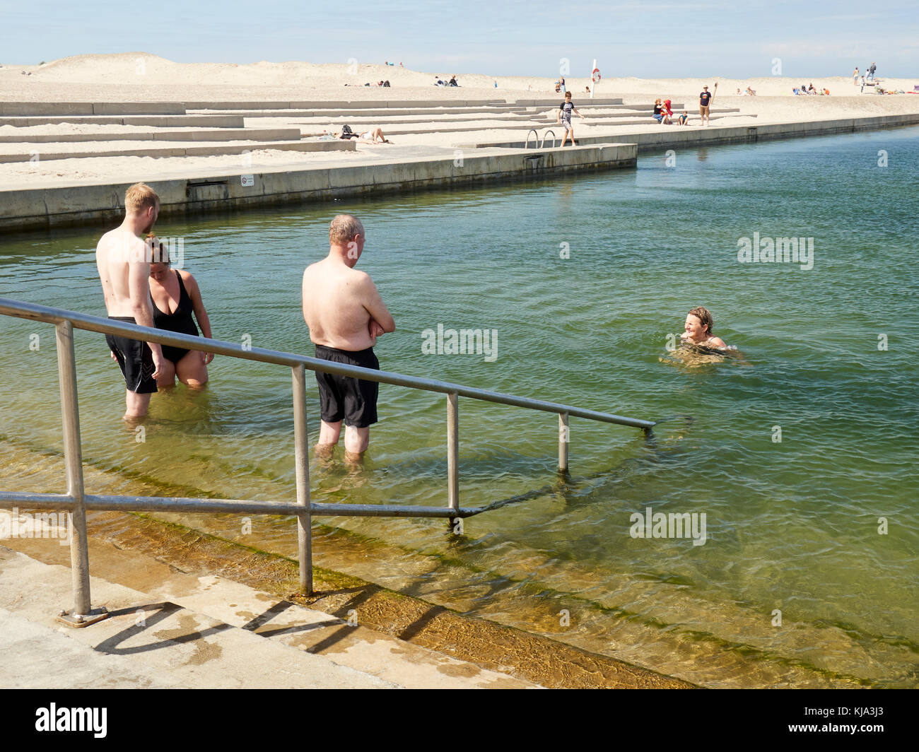 People swimming in the open salt water pool, Nr. Vorupør, Denmark Stock Photo