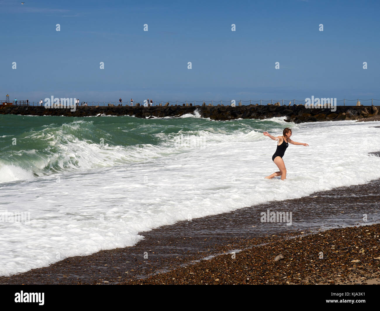 Girl escaping waves Stock Photo