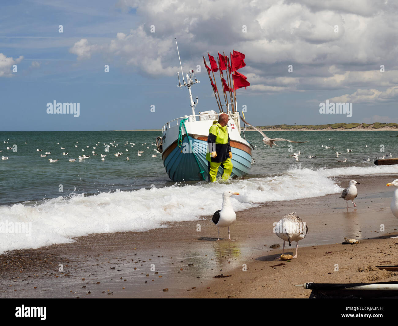 Fishing boat arriving at the beach, Nr. Vorupør, Denmark Stock Photo