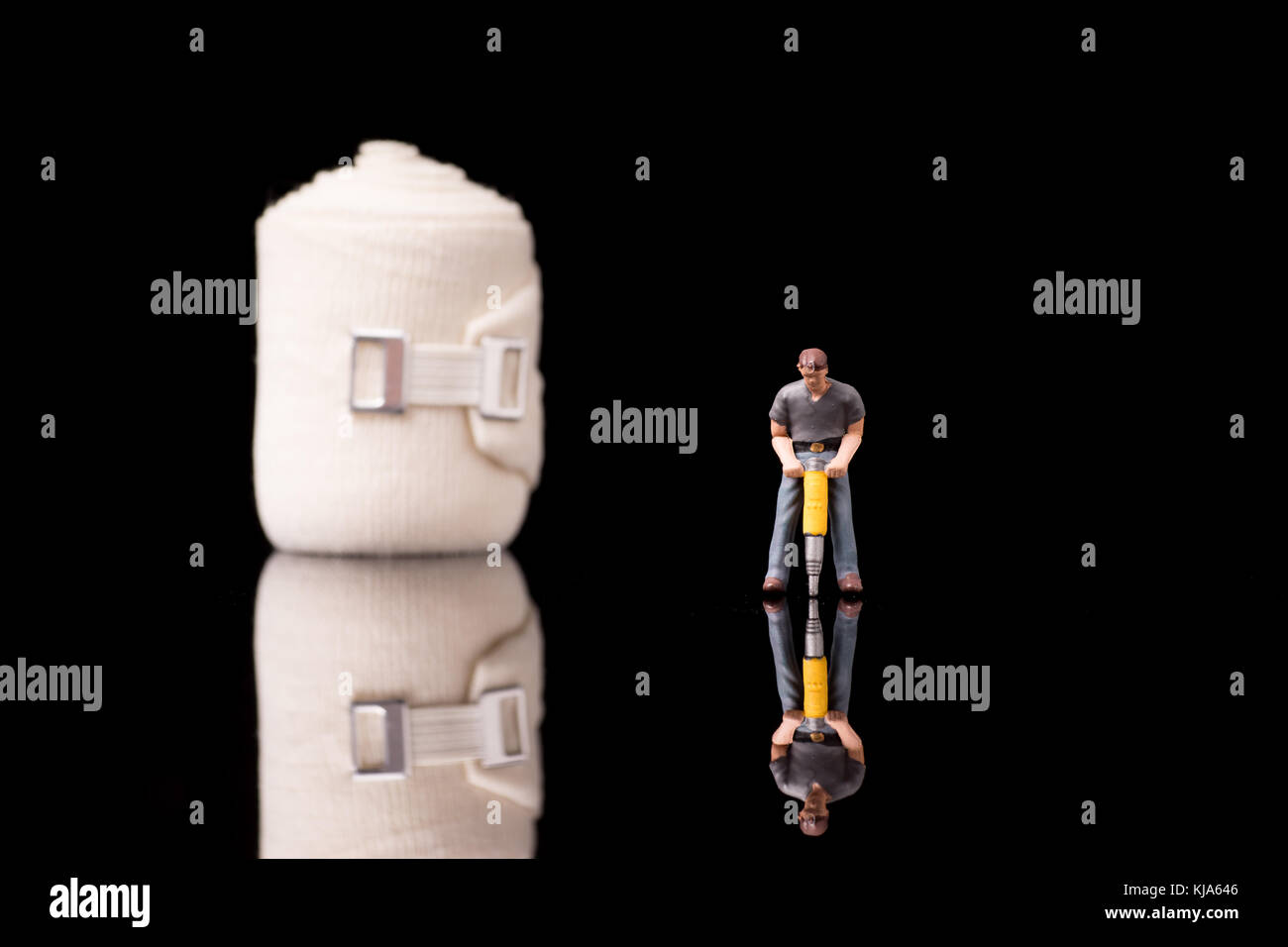 Bandage used for injuries during work, leisure time or in housework, isolated on glossy black background Stock Photo