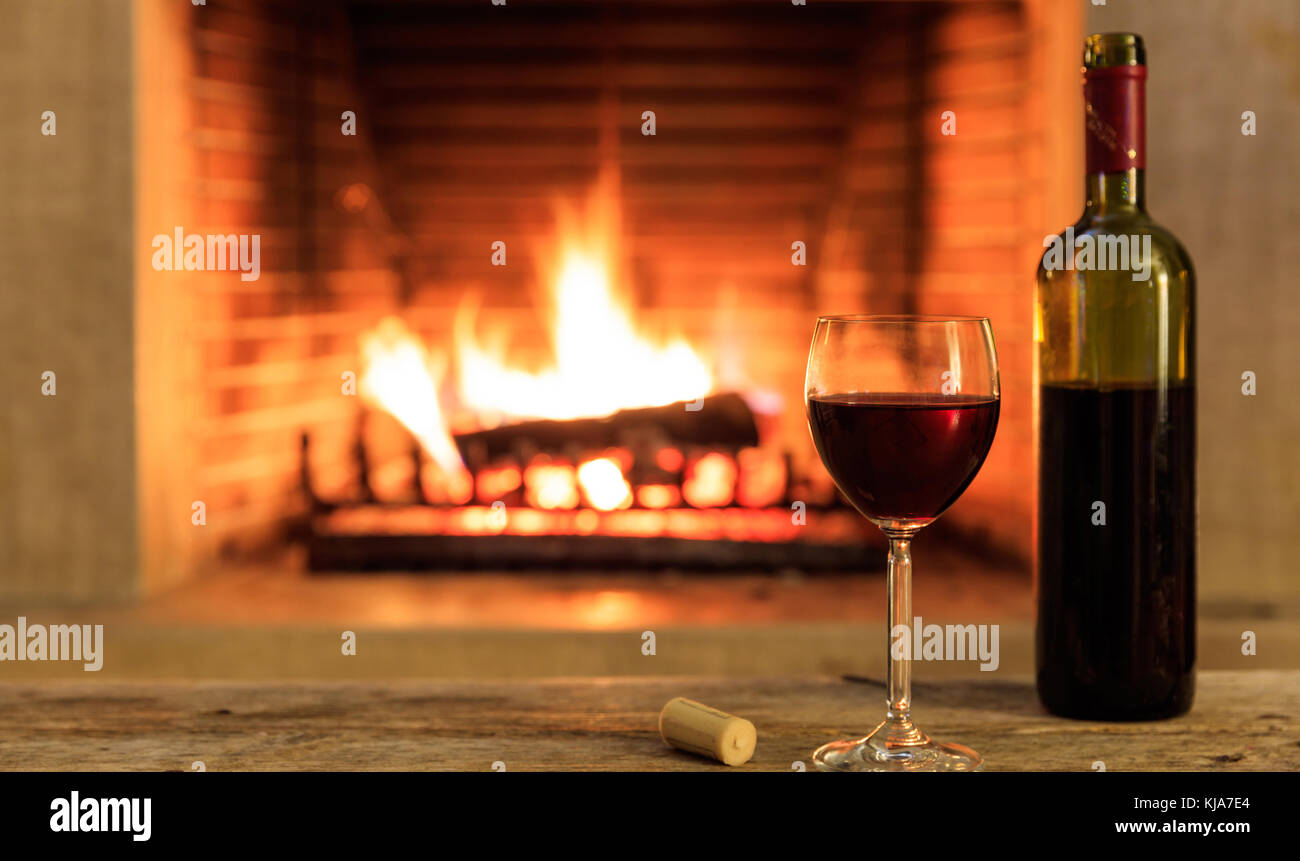 Download A Glass And A Bottle Of Red Wine On A Wooden Table Blur Burning Stock Photo Alamy PSD Mockup Templates