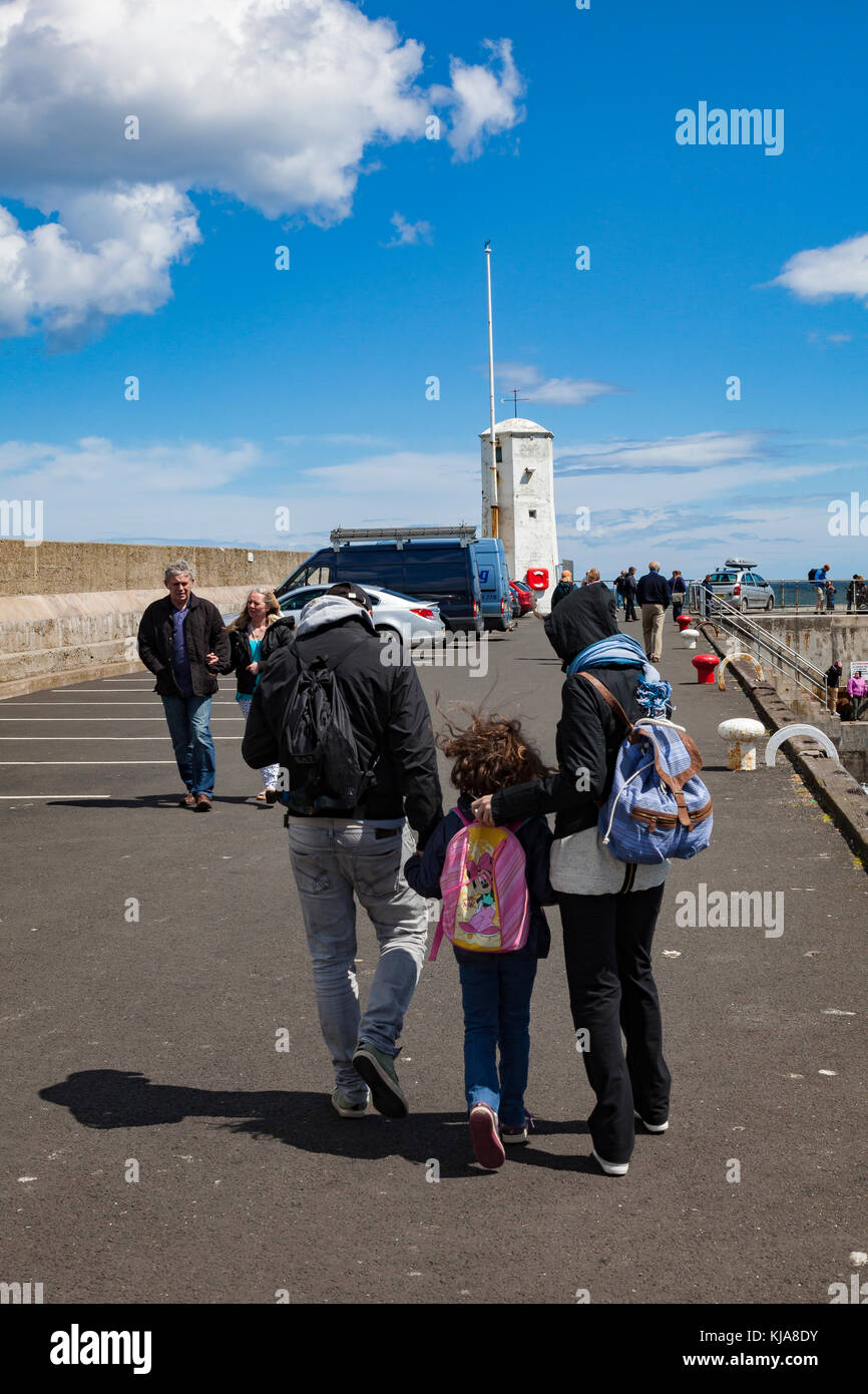 Summer crowds of family visitors at Seahouses, many catching boat trips to the Farne Islands, Northumberland, UK Stock Photo