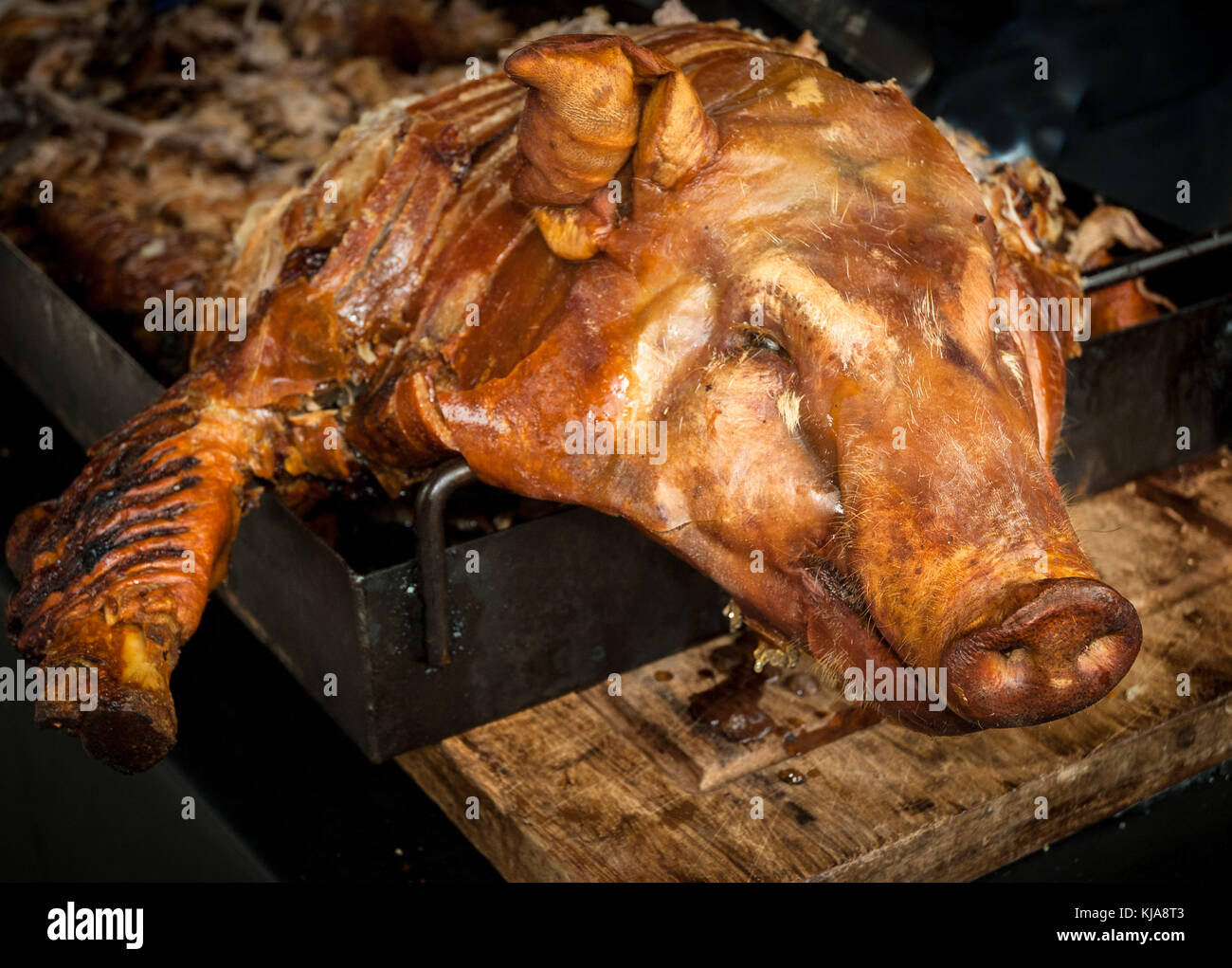 Spit roasted pig at a banquet. Stock Photo