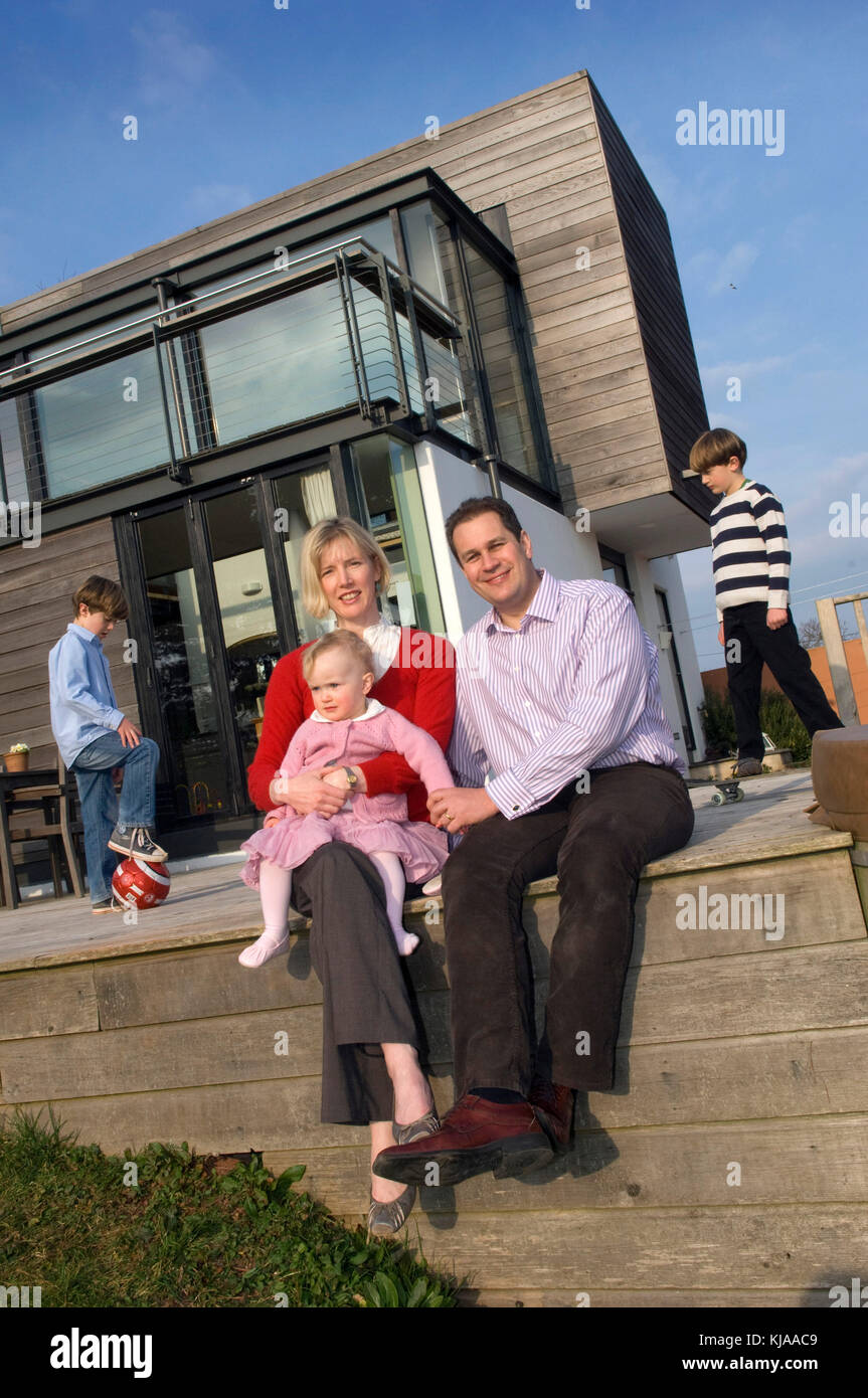 Family standing front of their home Stock Photo - Alamy
