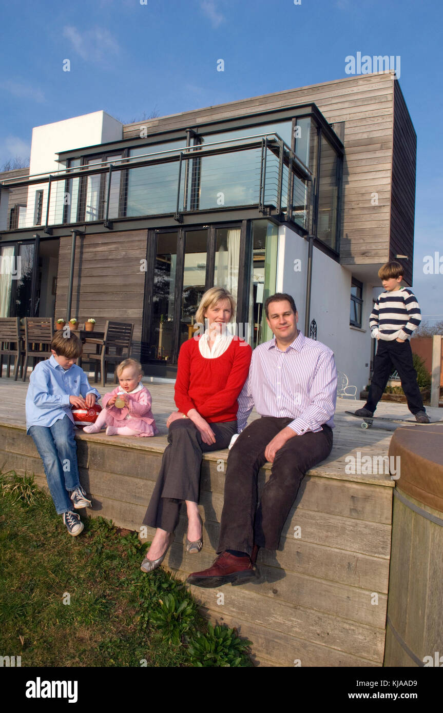 Family standing front of their home Stock Photo - Alamy