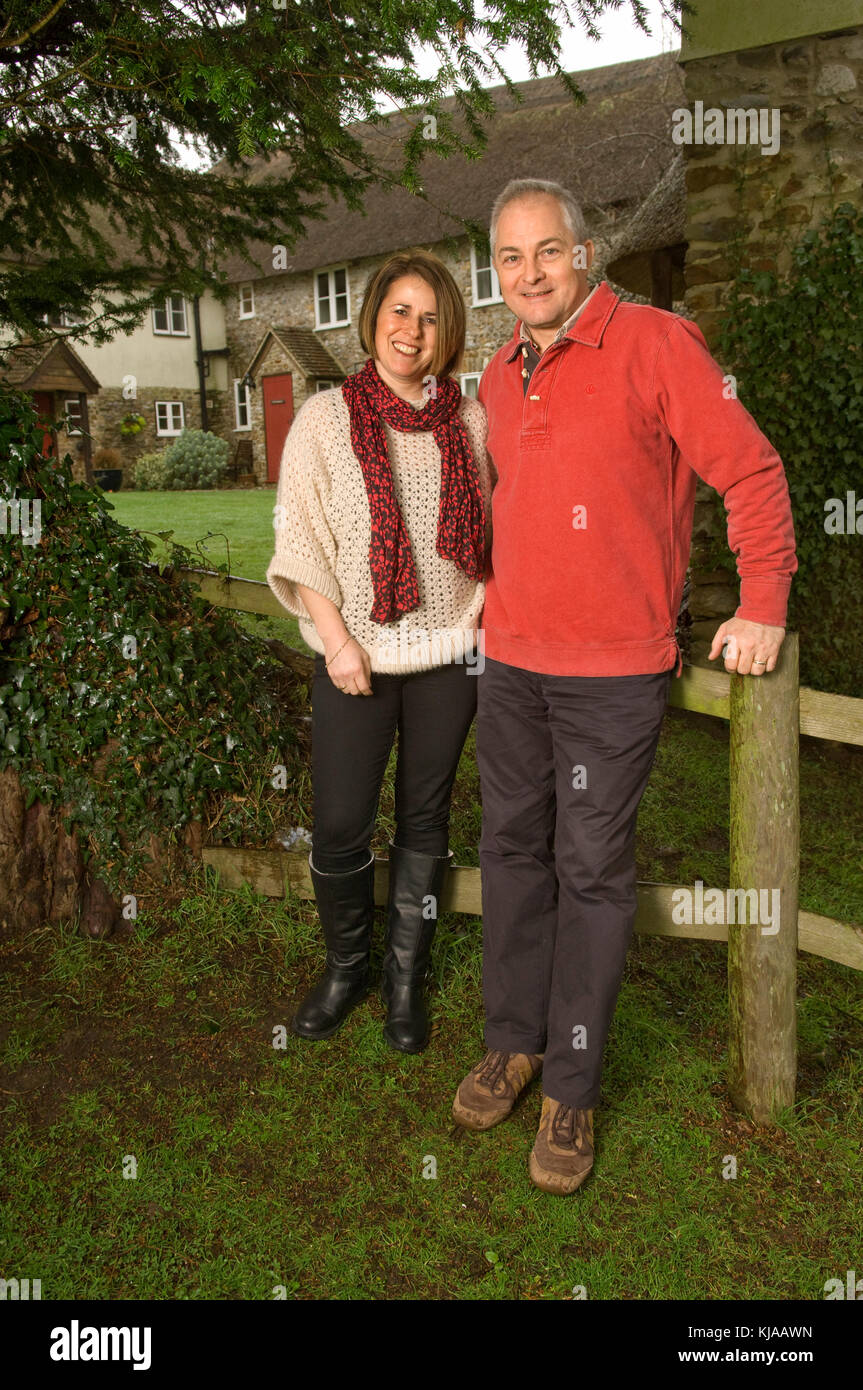 Couple standing front of their home Stock Photo - Alamy