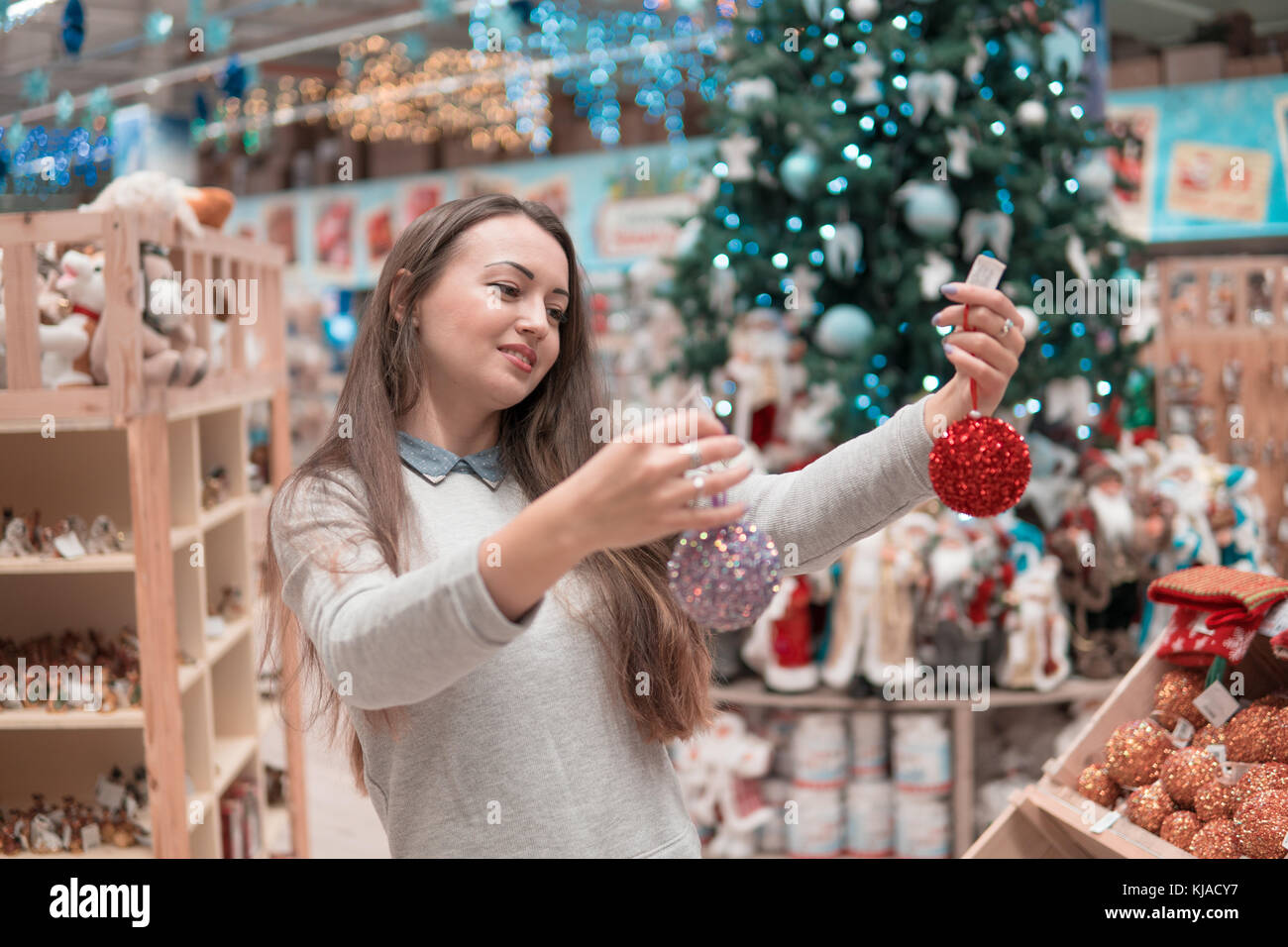 customer girl choosing gifts for Christmas and New Year Stock Photo