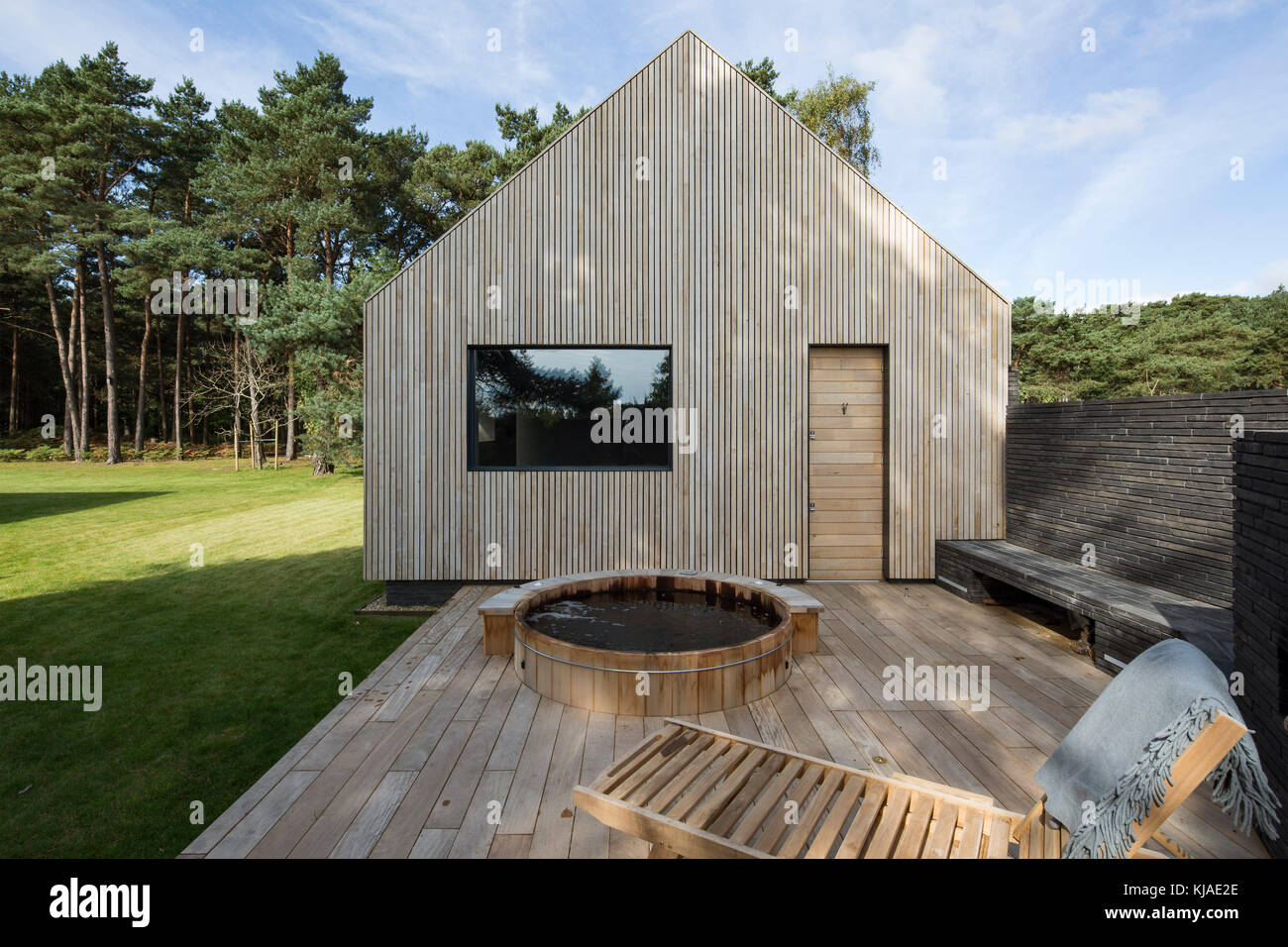 View of east facade with decking and hot tub. Watson House Annexe