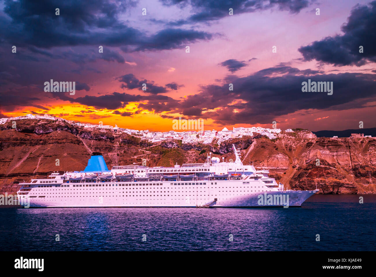Santorini, Cyclades Islands, Greece. Luxury cruise ship in the bay of Santorini at sunset Stock Photo
