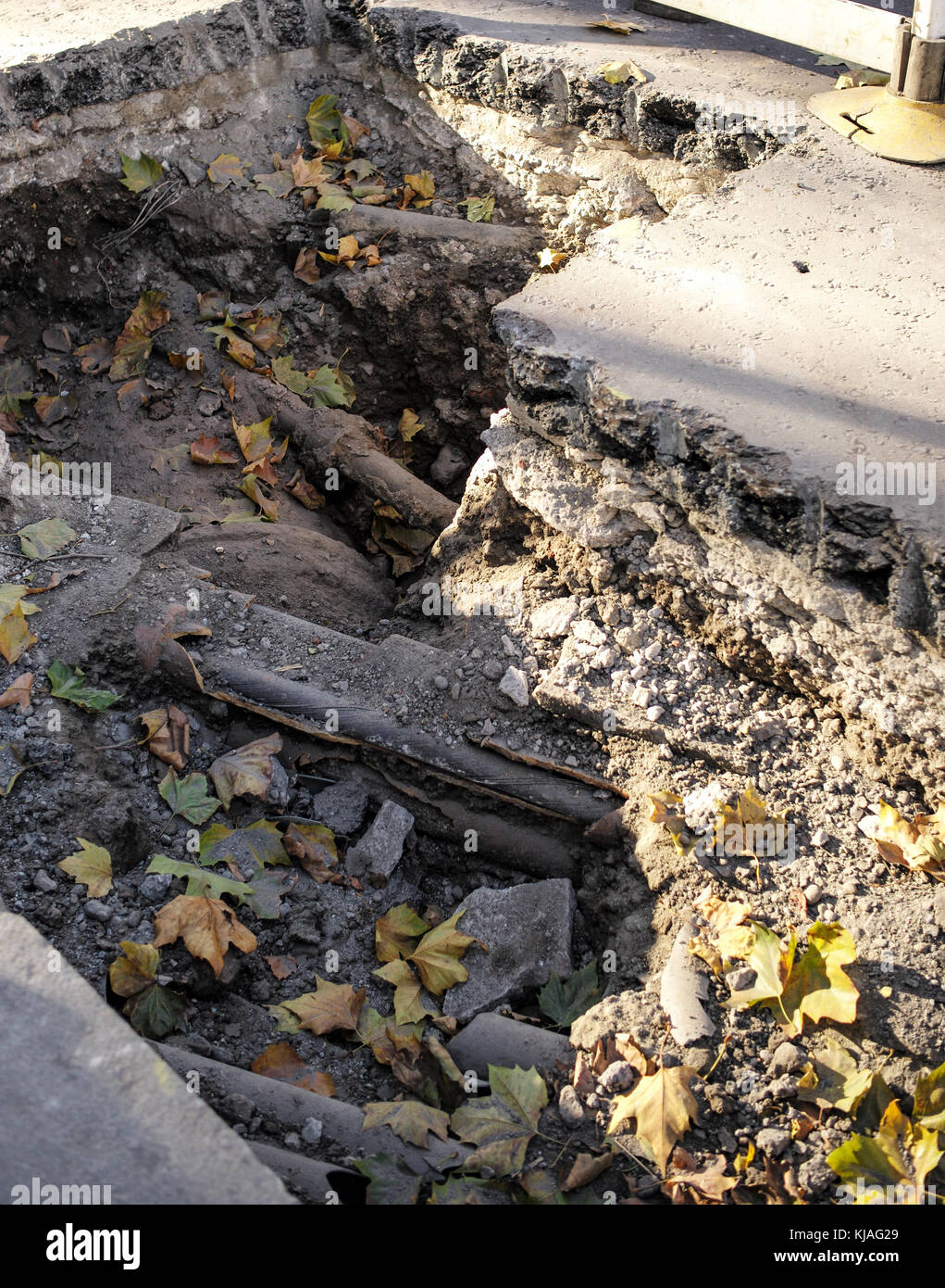 A hole in the road exposing utilities in central London England Stock Photo