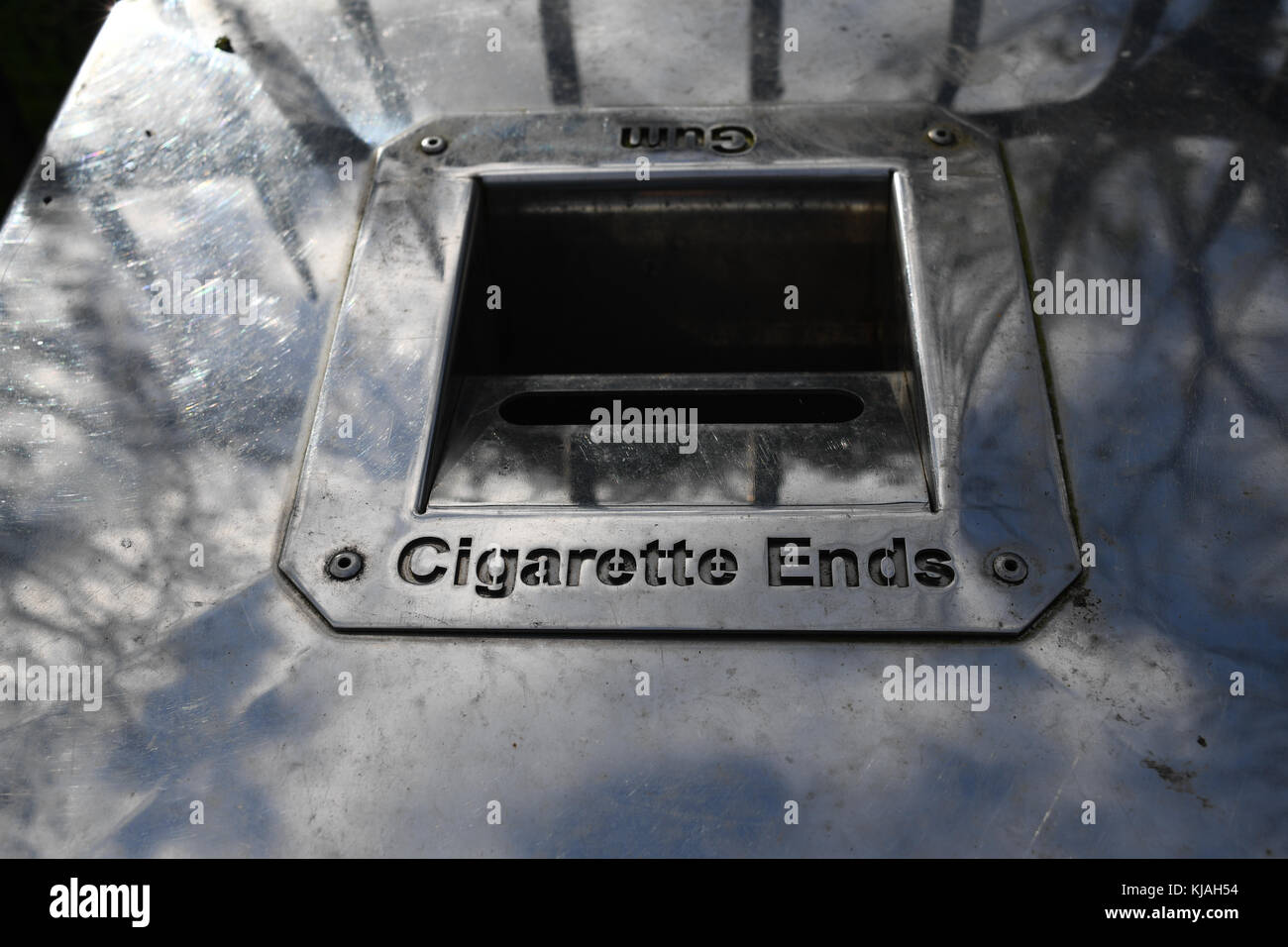 A waste bin with cigarette ends and gum tray.cigarette bin Stock Photo