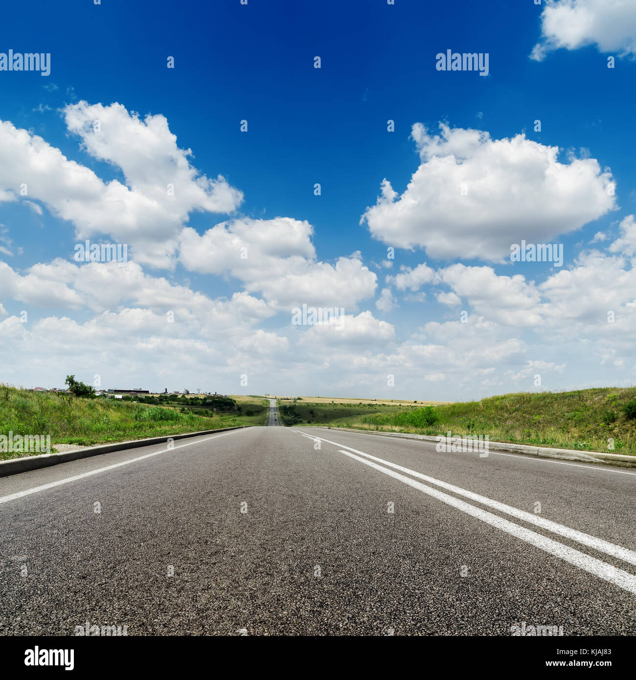 asphalt road to horizon and deep blue sky with white clouds Stock Photo ...