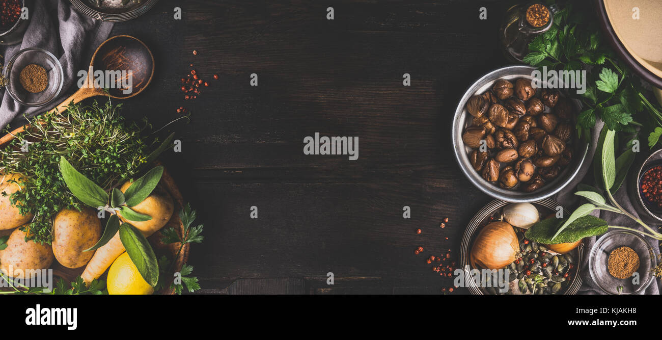 Chestnuts cooking ingredients on dark rustic background, top view, place for text. Seasonal food and eating. Banner Stock Photo