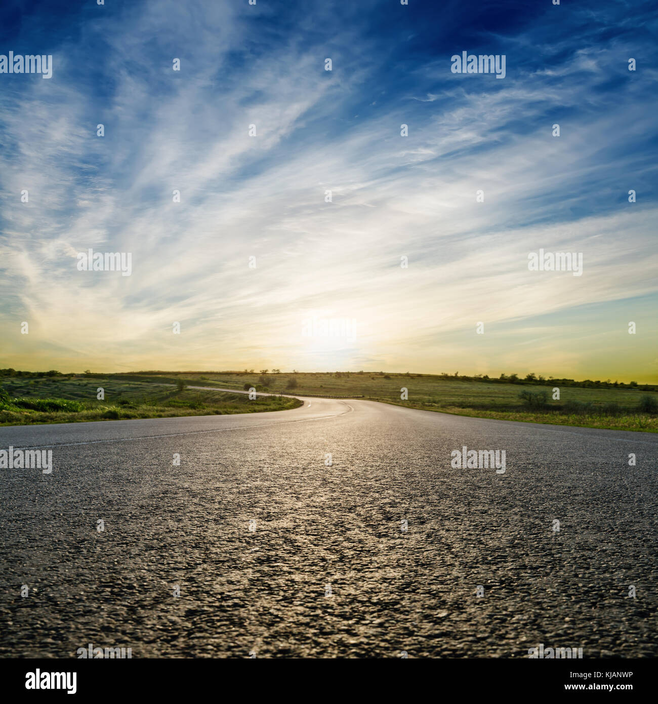 sunset in blue sky over asphalt road. soft focus Stock Photo - Alamy