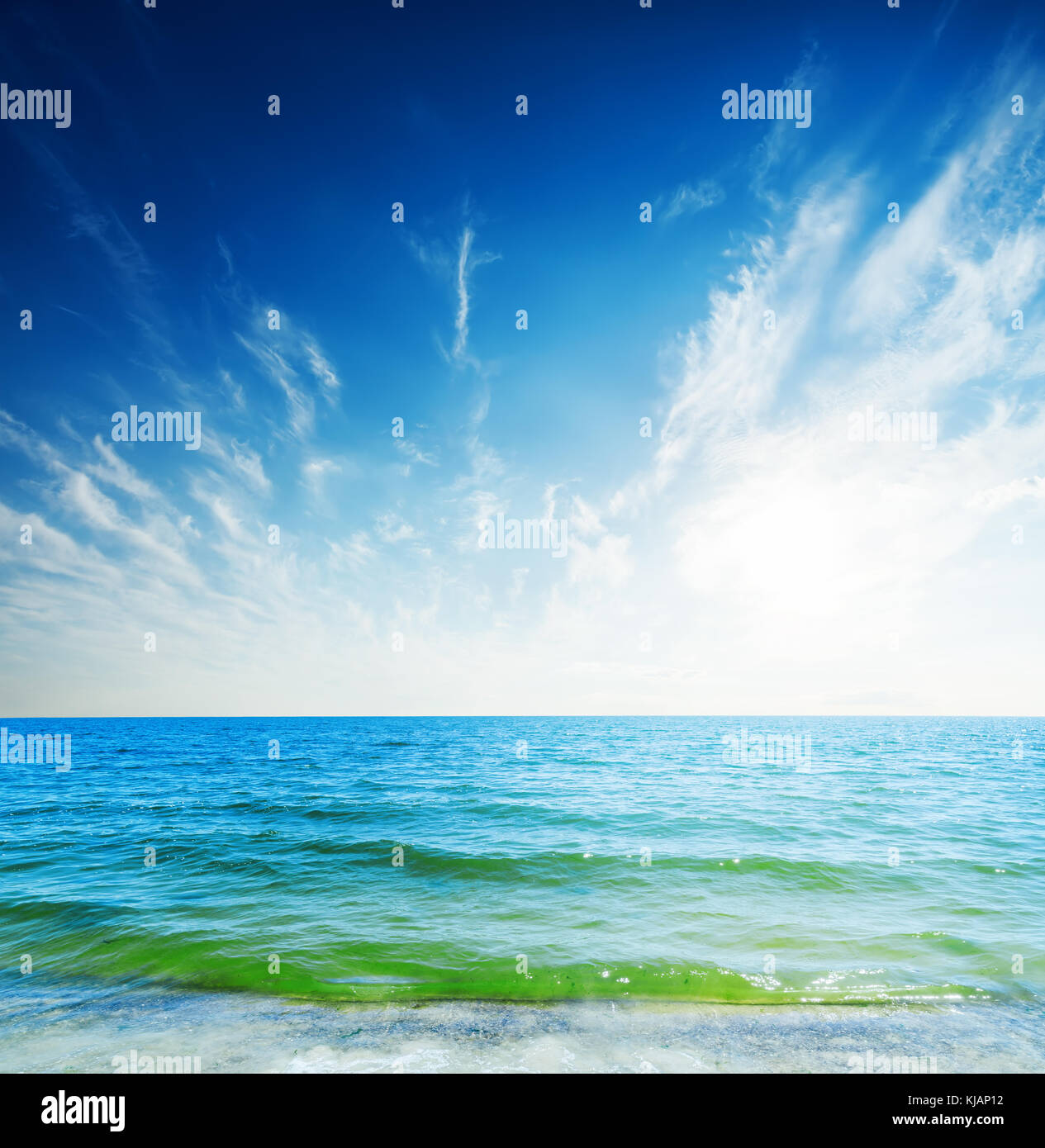 blue sky with clouds and sun over sea Stock Photo - Alamy
