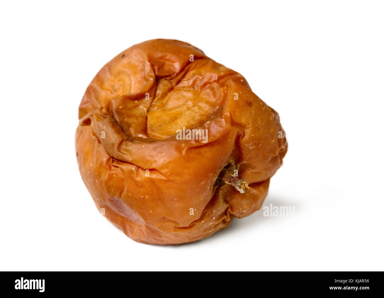 Old rotten apple on white isolated background, unhealthy to eat Stock Photo