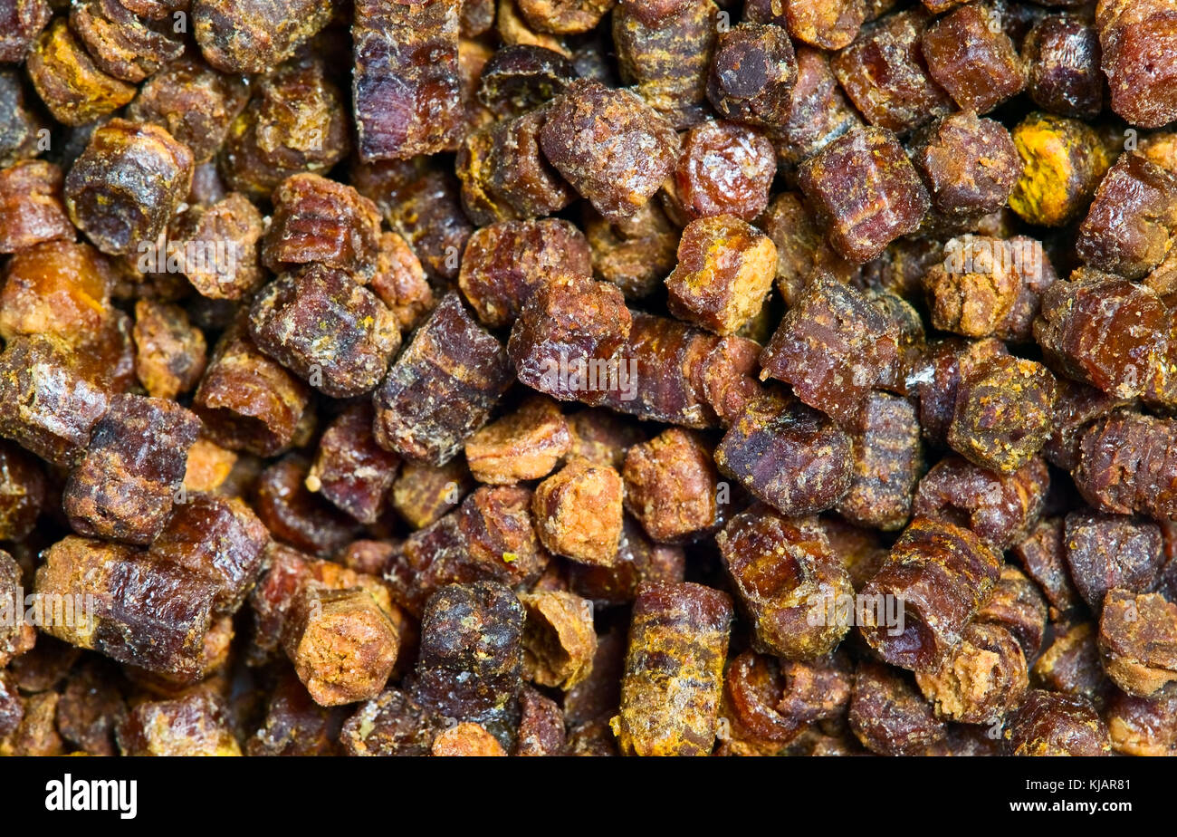 Propolis granules grunge texture background, bee product Stock Photo