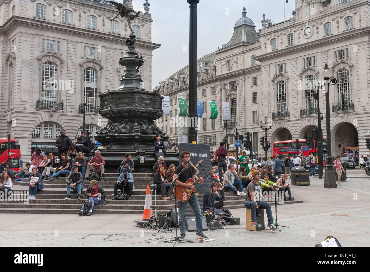 Piccadilly Circus, London-September 6,2017: Tourists sitting and listening music band on the steps of the Fountain in Piccadilly Circus on September 6 Stock Photo