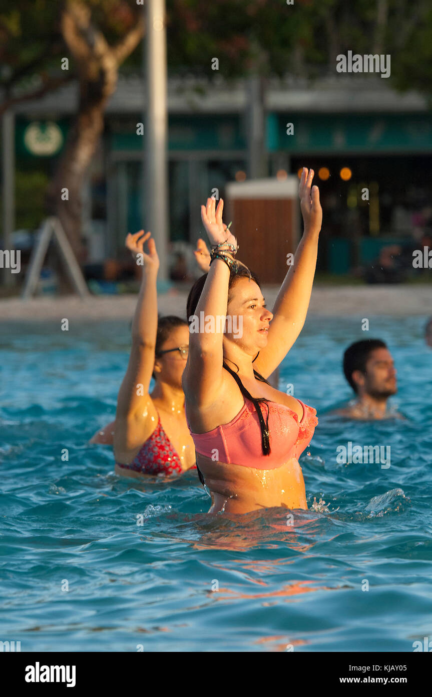 Young woman participating in aqua zumba in the Lagoon in Cairns, Far North Queensland, FNQ, QLD, Australia Stock Photo