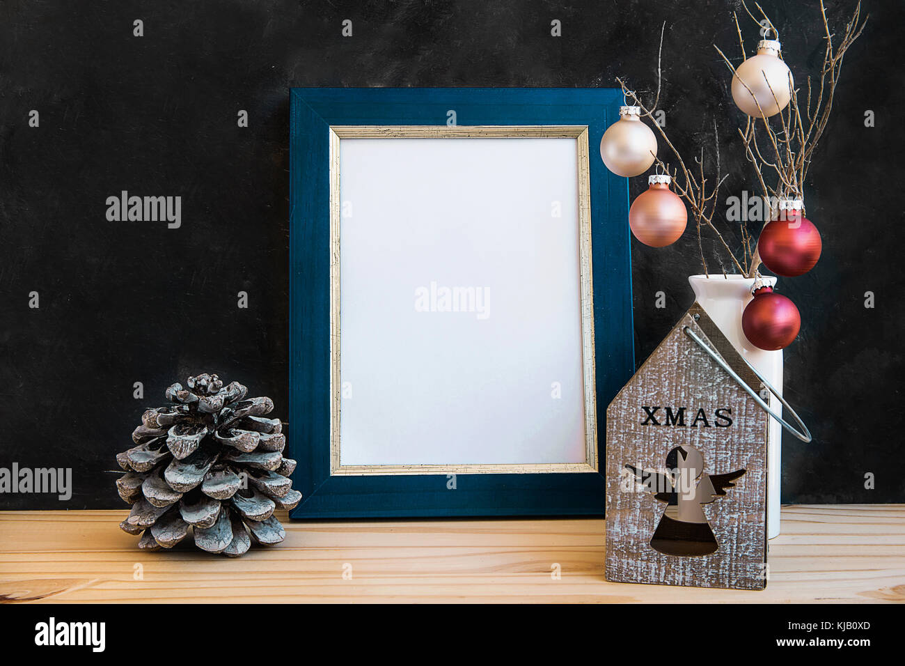 Blue Golden Frame Mock Up Christmas New Year Pine Cones Colorful Balls Candle Holder with Angel Figure Black Chalkboard Wall Blank Space for Quotes Le Stock Photo