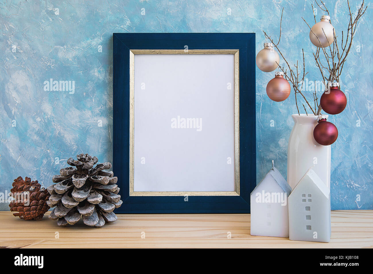 Blue Golden Frame Mock Up Christmas New Year Pine Cone Colorful Balls on Tree Branch House Candles Pastel Color Wall Blank Space for Quotes Lettering  Stock Photo