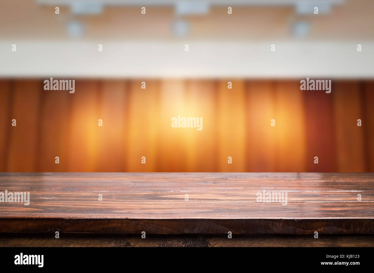 Empty wood table and blurred booked cafe light background. product display template. Business presentation. Stock Photo