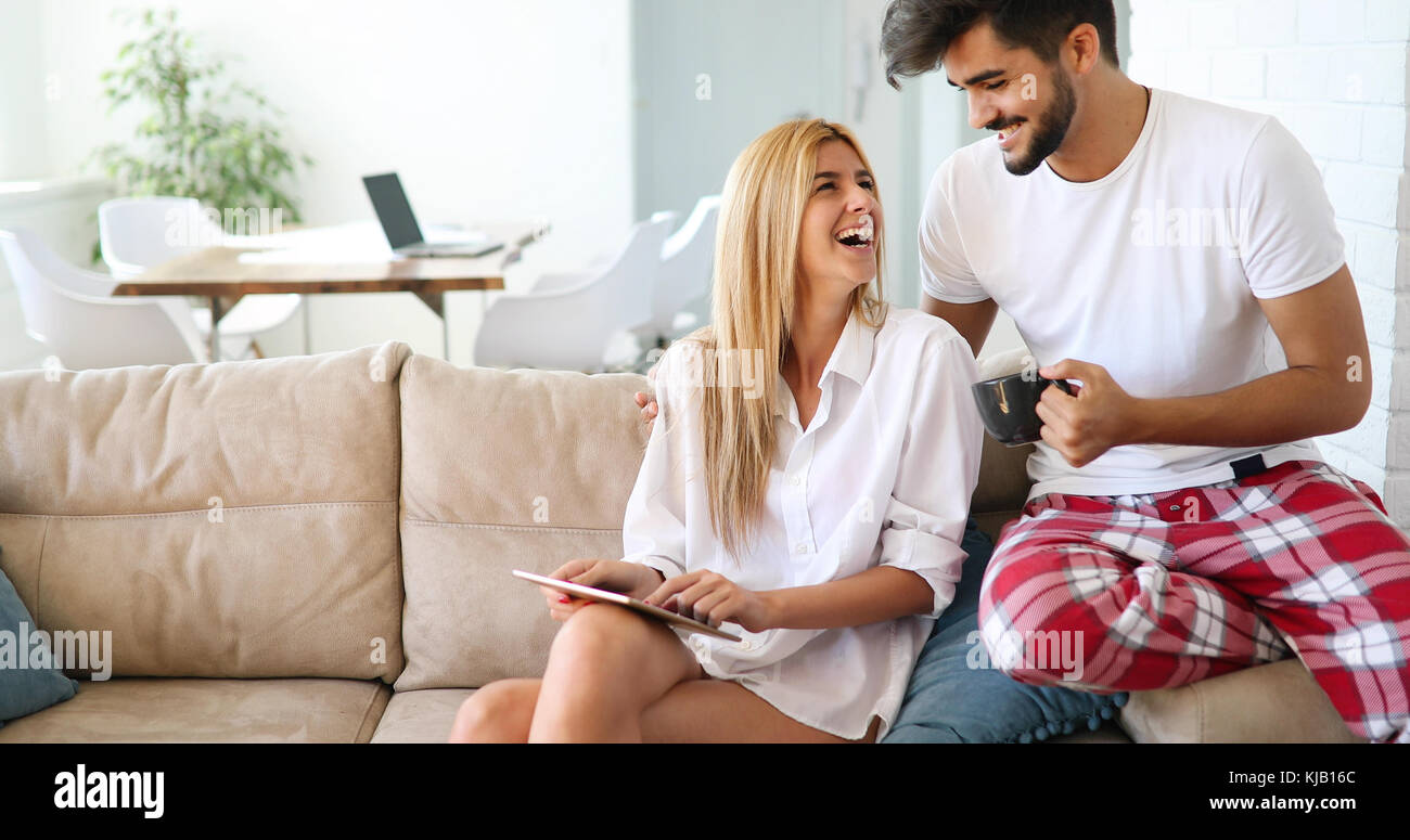 Young attractive couple spending time together at home Stock Photo - Alamy