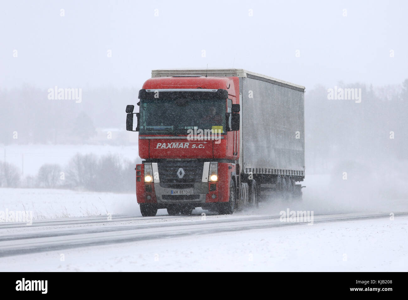 SALO, FINLAND - FEBRUARY 24, 2017: Red Renault Magnum semi truck transports goods during heavy snowfall  in South of Finland. Stock Photo