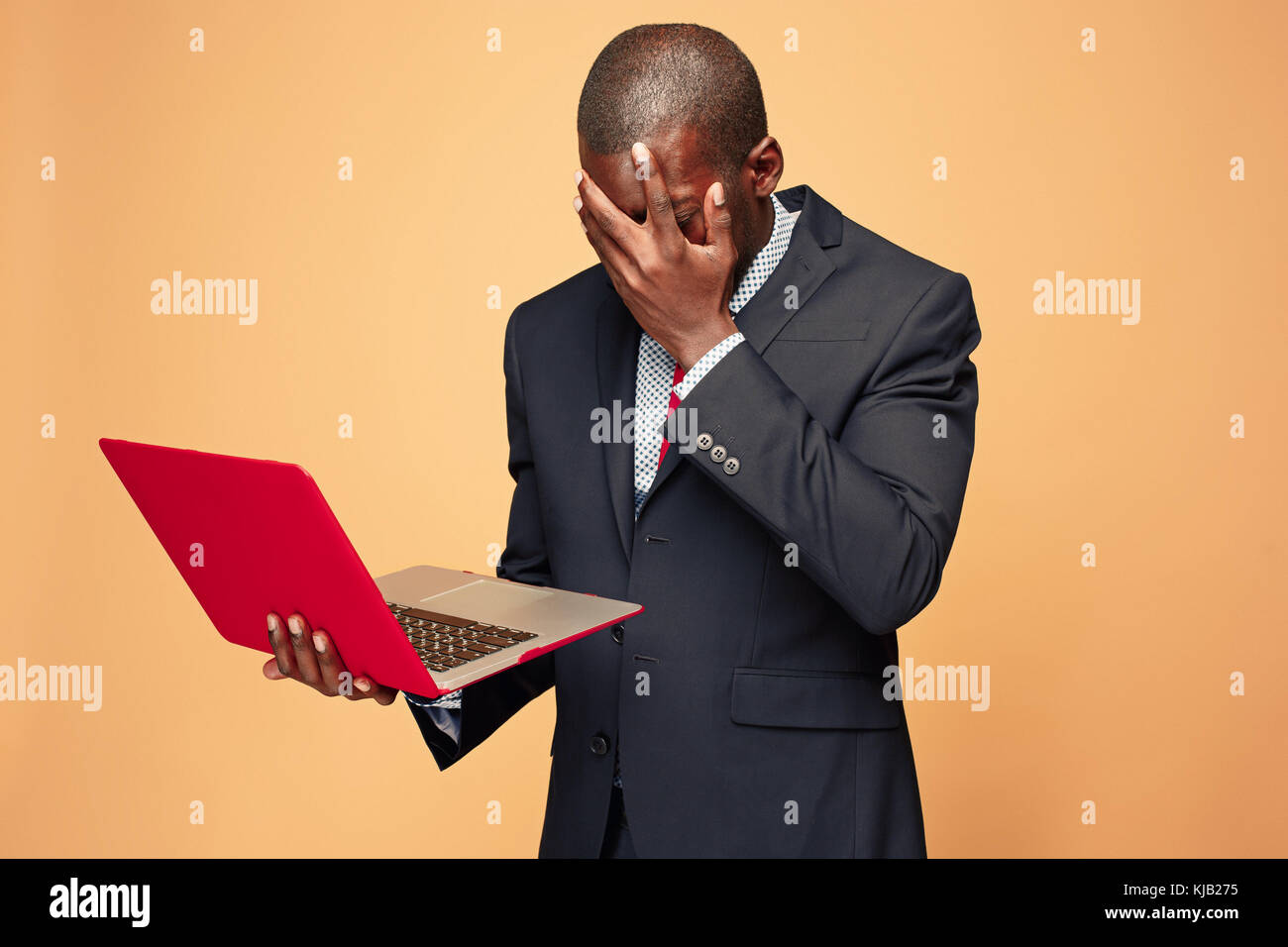 Handsome Afro American man sitting and using a laptop Stock Photo - Alamy