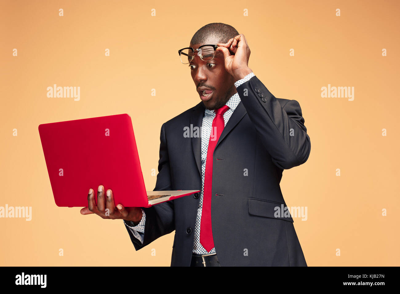 Handsome Afro American man sitting and using a laptop Stock Photo - Alamy