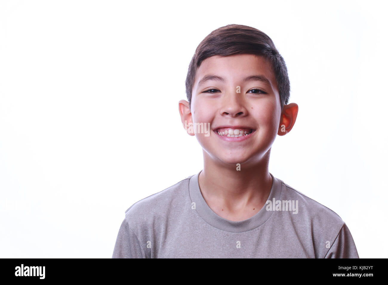 A portrait of a smiling young boy set against a white background Stock ...