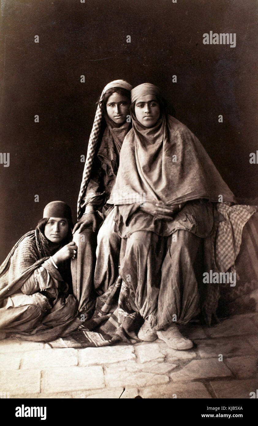 Three women tiredly look at Antoin Sevruguin as he photographs them in the late 19th century. Stock Photo