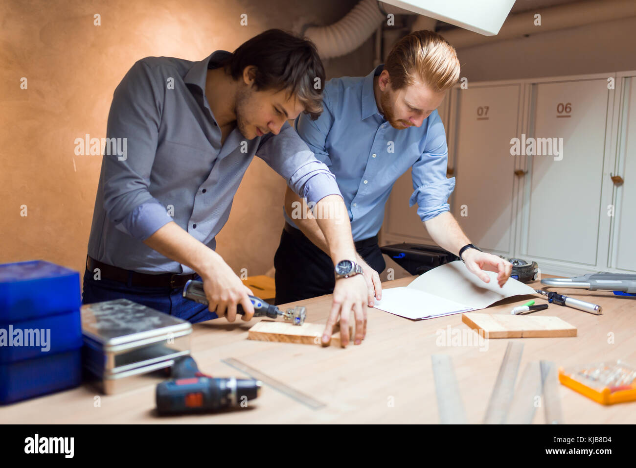 Two creative designers working in workshop Stock Photo