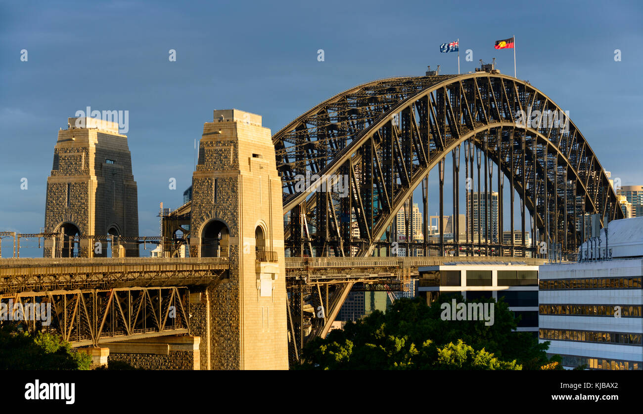 Close-up image of the Sydney Harbour Bridge from Milson's Point train station at sunset with dark clouds. Stock Photo