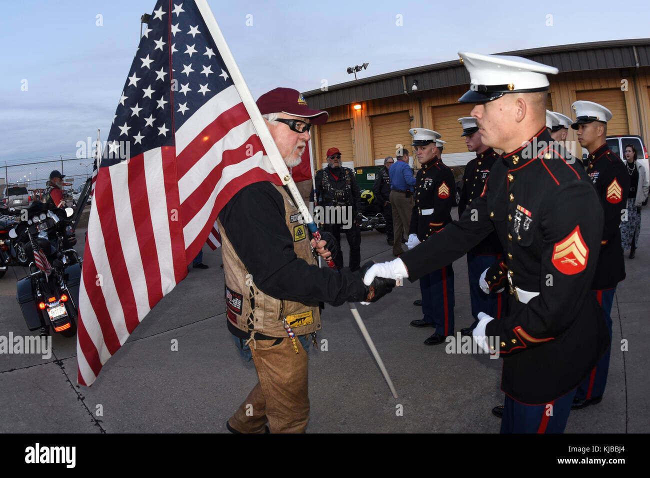 Phil Lutes, an Oklahoma Patriot Guard Rider, carries an American flag