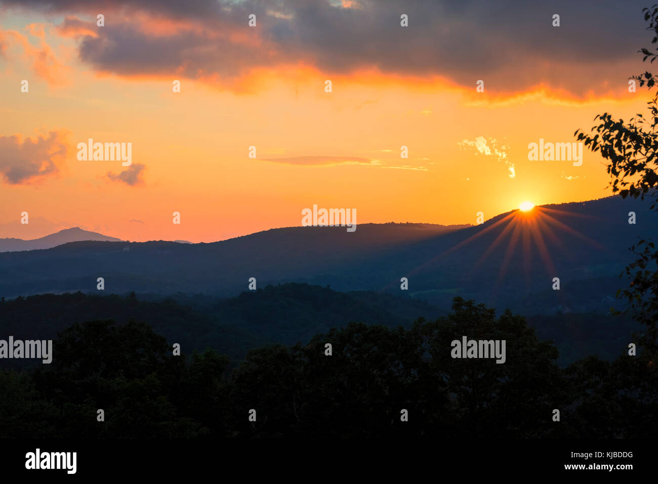 The sun sets behind a ridge near Blowing Rock in the Blue Ridge Mountains of North Carolina. Stock Photo