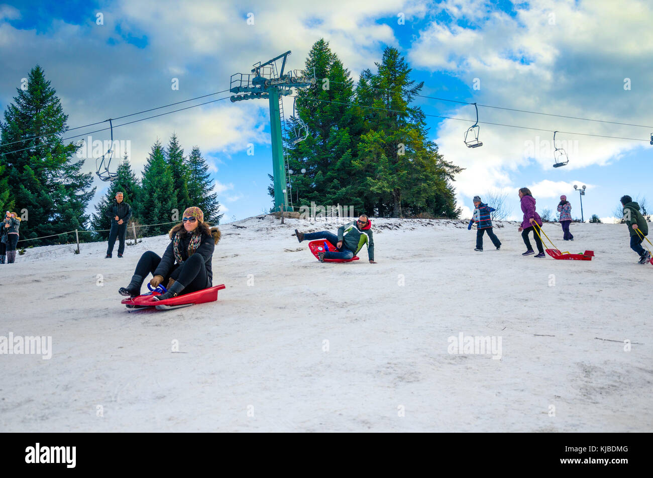 Family have fun with ski vehicles at Pertouli ski center, trikala, Greece on December 27, 2016. Stock Photo