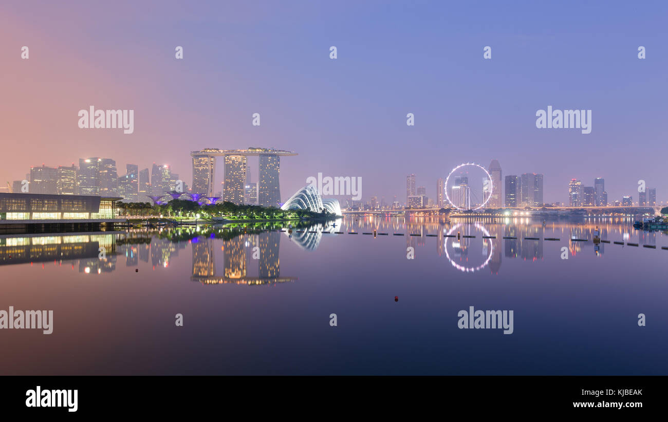 Singapore skyline with CBD, Central Business District, Gardens by the Bay, Sands hotel and Flyer wheel reflecting in Marina Bay, at sunrise, from the  Stock Photo
