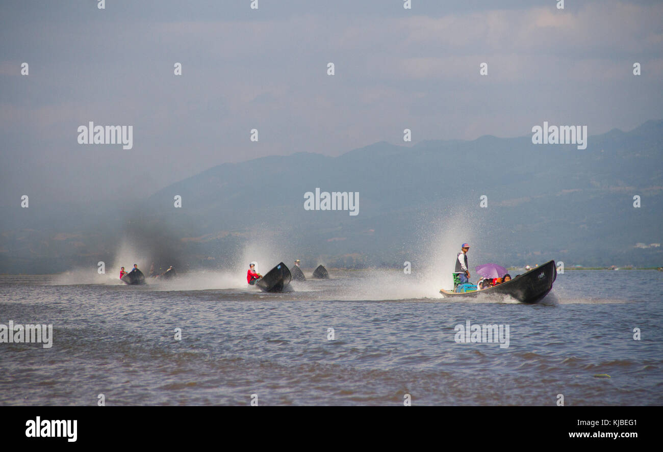 Tourists ride on motorboats across Inle Lake in Myanmar. Inle lake is a ...