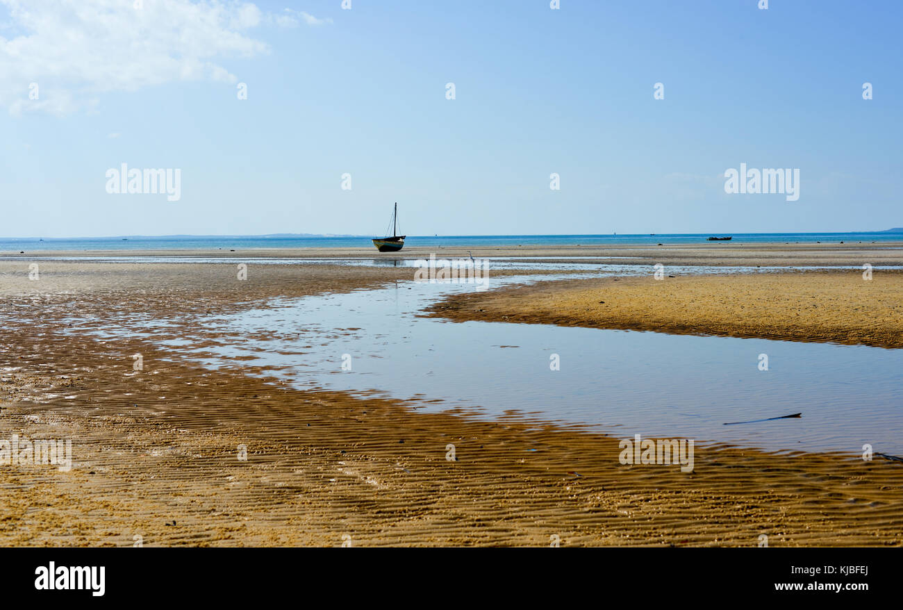 Panoramic View of Vilanculos Beach in Mozambique during low tide. One can see the various dhows resting in the sand. Stock Photo