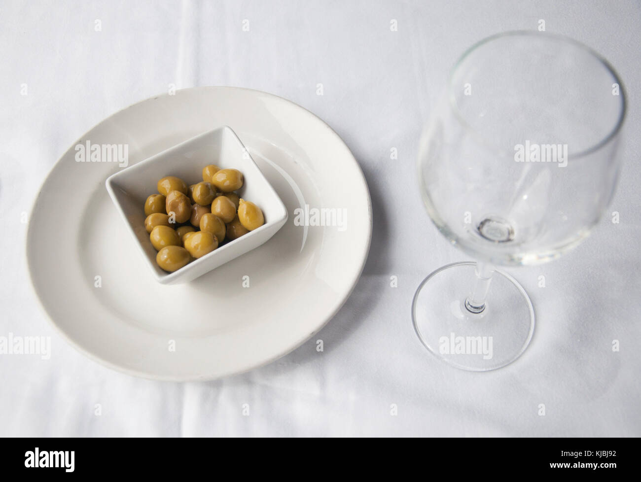 Green olives in a dish like an appetizer Stock Photo
