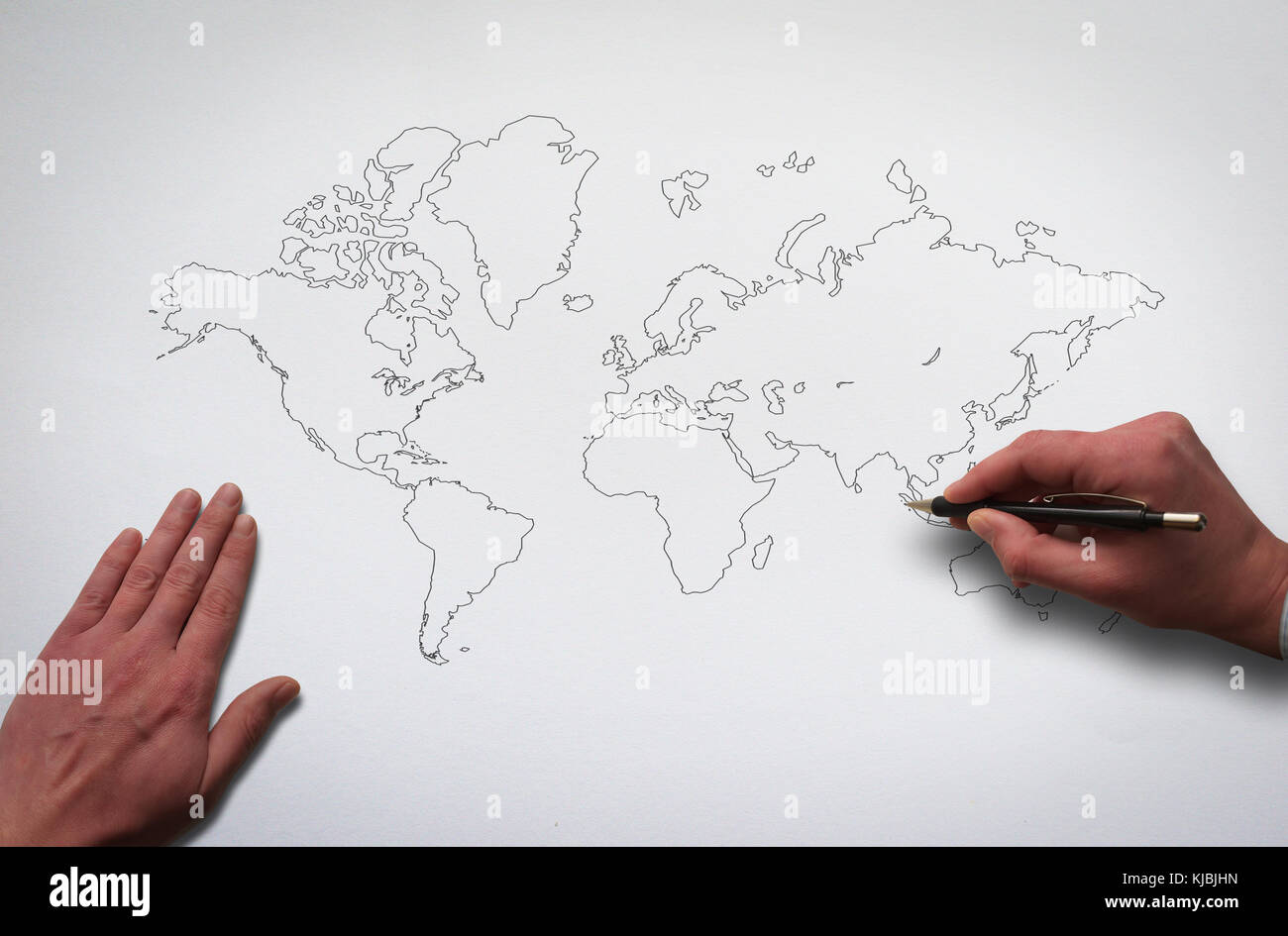 Hands drawing world map. Outline world map on the old paper texture background. Hands drawing contour of global map with pencil. Stock Photo