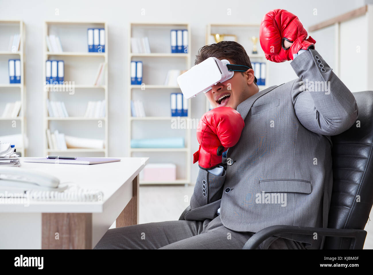 Man boxing in the office with virtual reality goggles Stock Photo Alamy