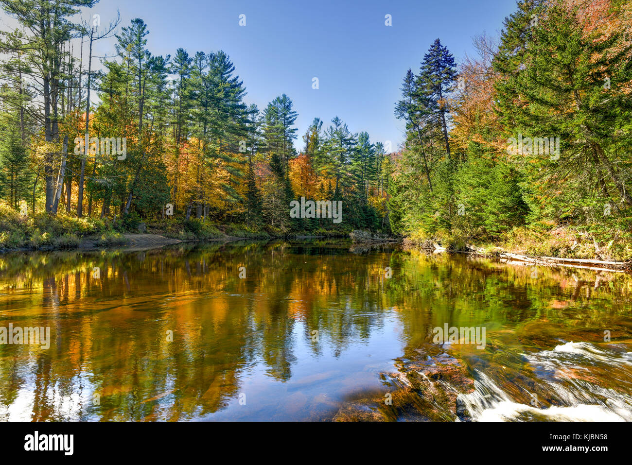 Adirondacks Peak Fall Foliage alongside Monument Falls, New York Stock