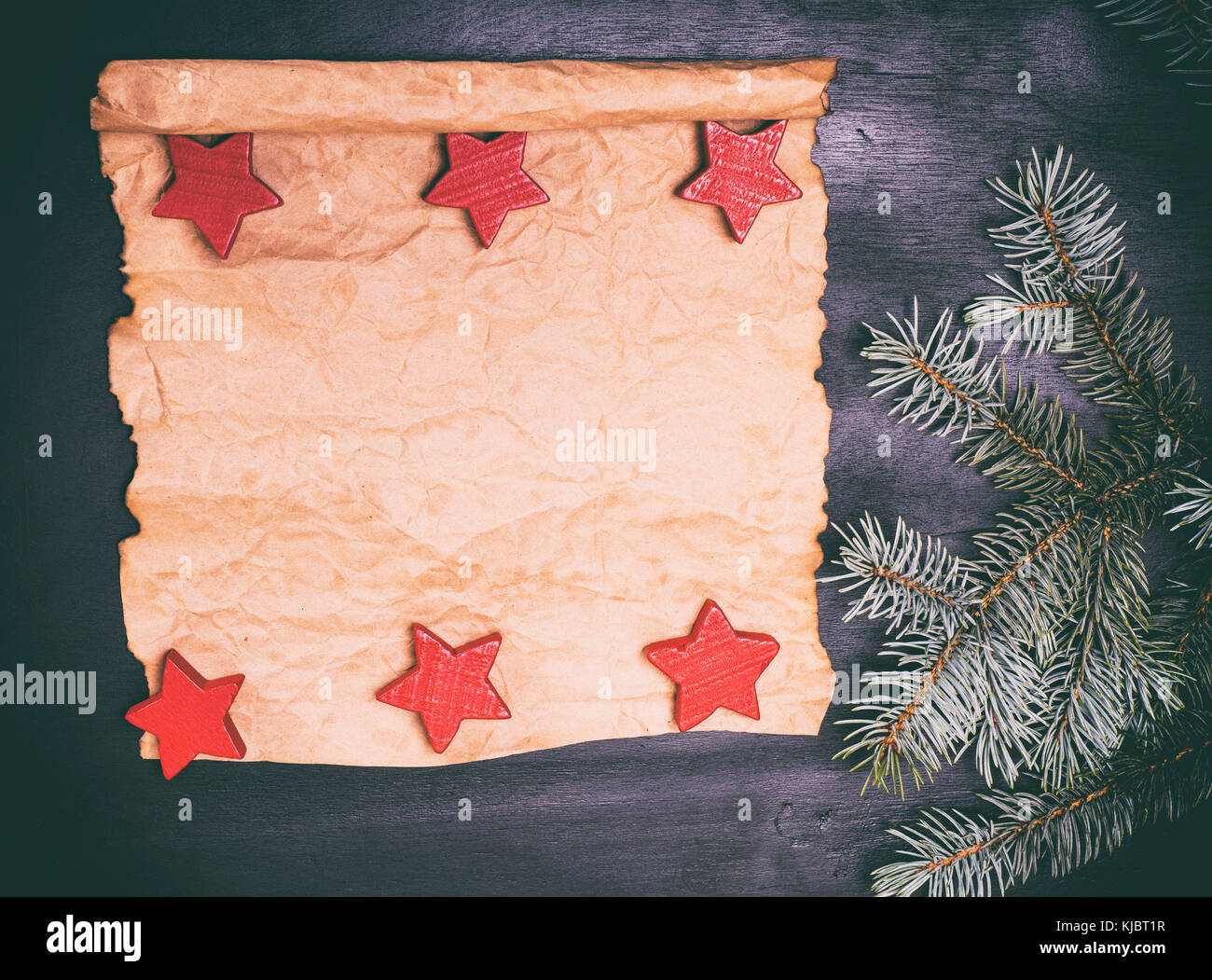 Empty paper roll on a black background and a green spruce branch Stock