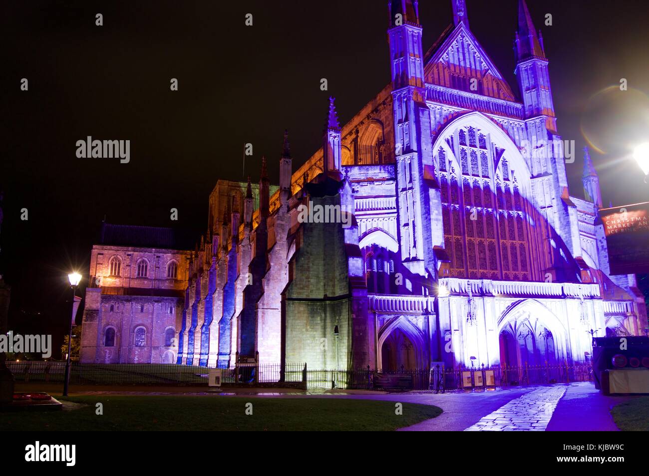 Winchester Cathedral exterior illuminated by purple lights, night, Winchester, UK Stock Photo