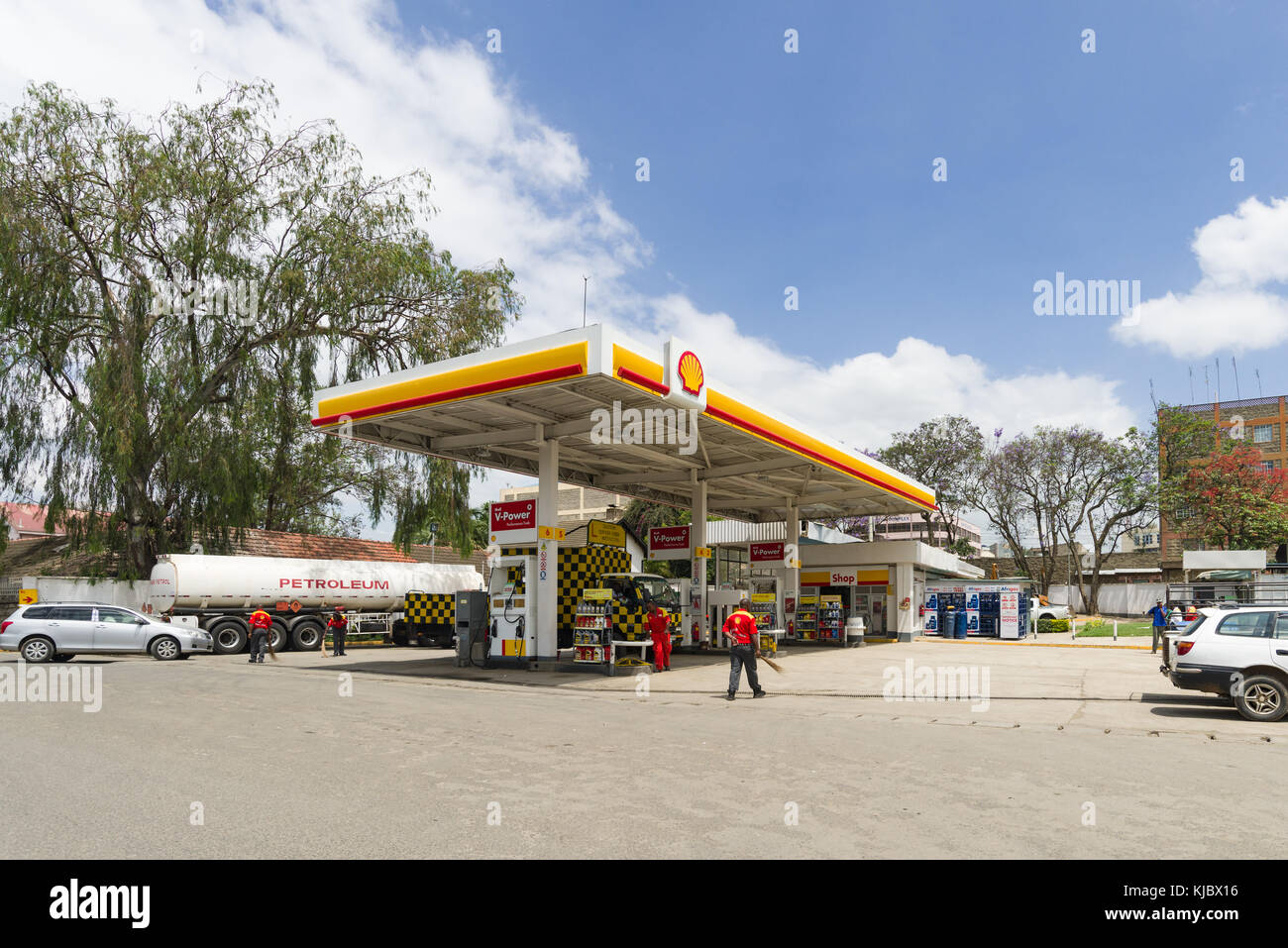 A Shell petrol station with attendants and customers at the fuel pumps, Kenya, East Africa Stock Photo