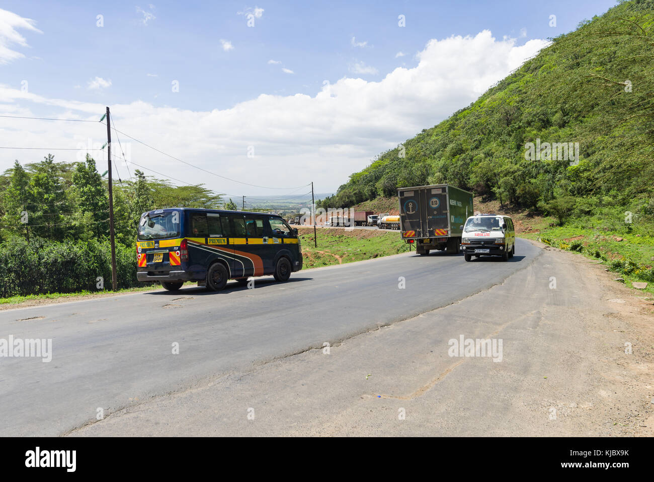Vehicles driving a busy section of road through the Rift Valley, Kenya, East Africa Stock Photo